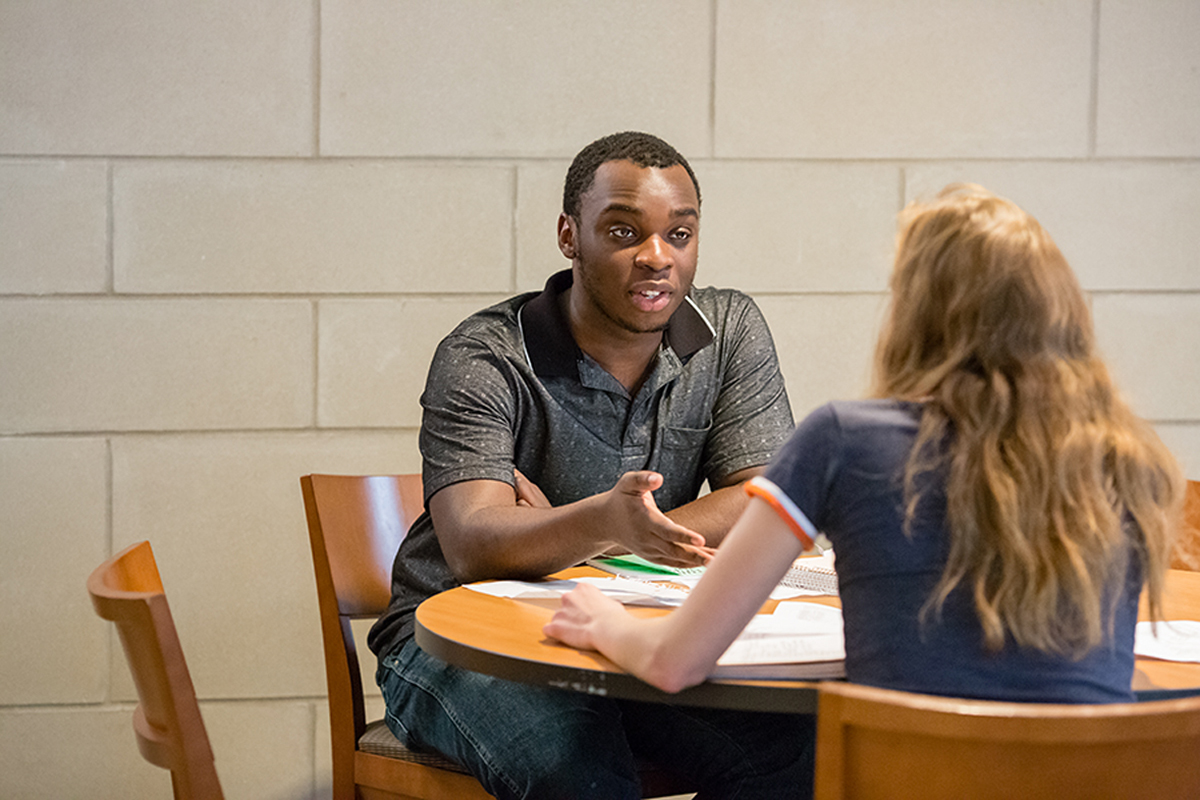 student and advisor sitting at table